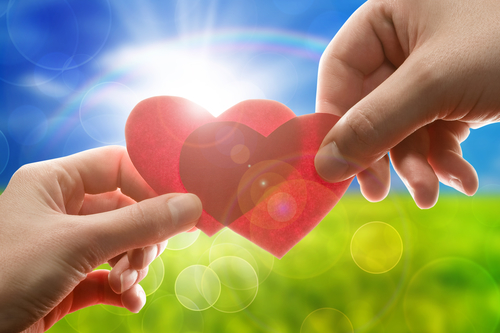 Female and man's hands with red hearts