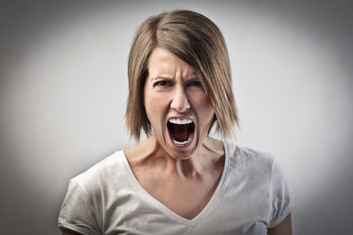 Portrait of a furious woman screaming
